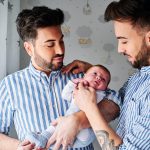 a gay couple with their son - gay parents concept