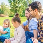 gay male couple with their children having a good time