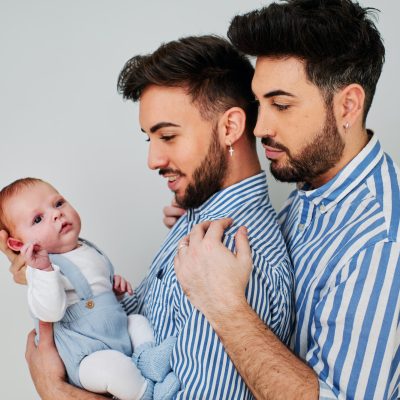a gay couple with their son - gay parents concept